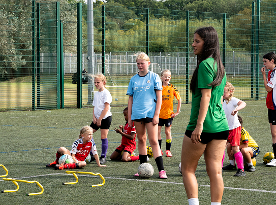 Young people playing sport outdoors